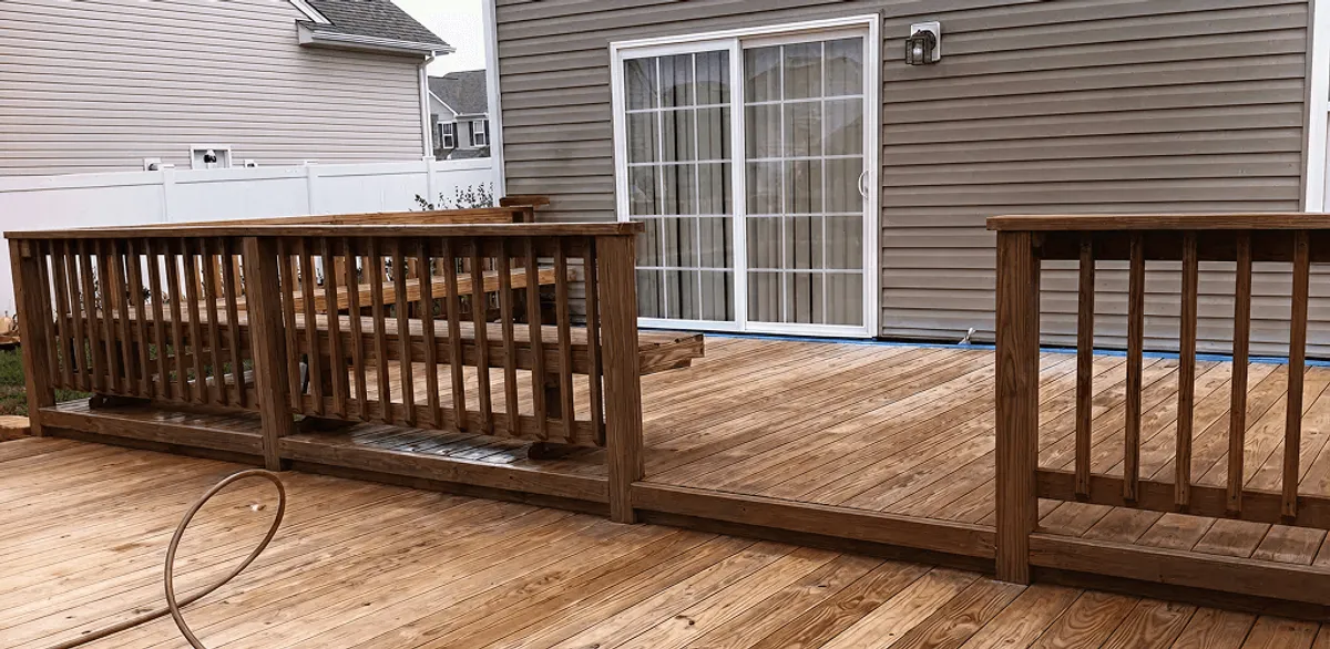 Deck sealing service protecting a backyard wood deck and railings in Portland, OR