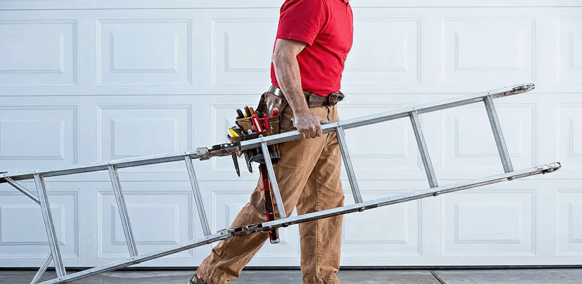 Garage door repair technician arriving with tools and ladder in Portland, OR