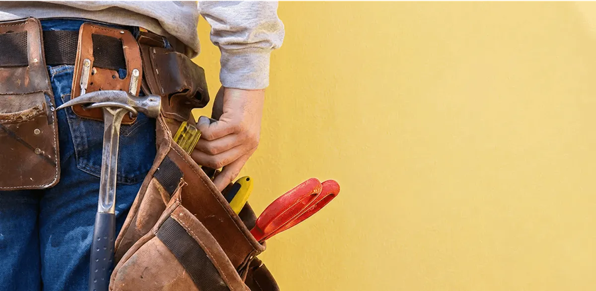 Handyman with tool belt ready for home repairs and maintenance in Portland, OR