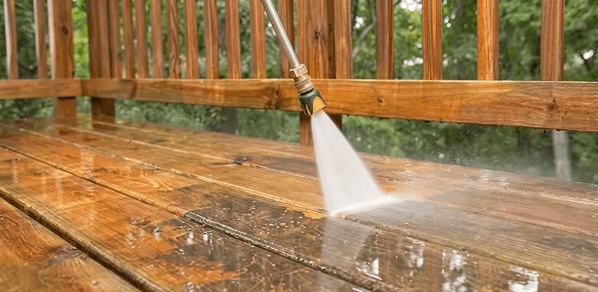 Pressure washing a wood deck to remove dirt and buildup in Portland, OR