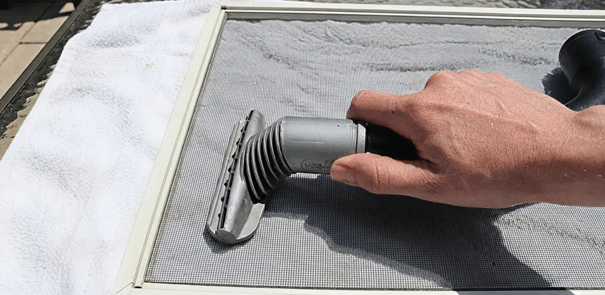 Window screen repair cleaning and fixing a damaged screen mesh in Portland, OR